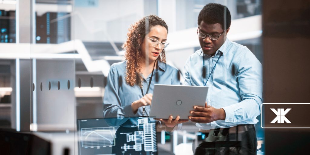 Workers looking at a laptop.