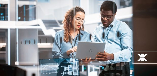 Workers looking at a laptop.